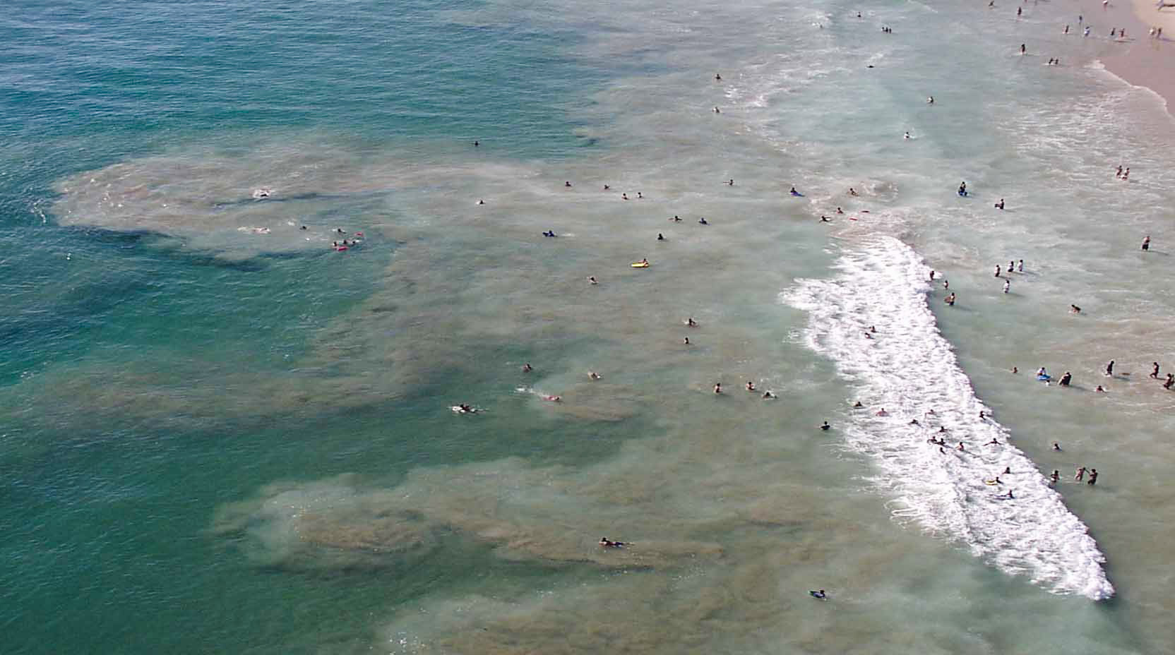 Wide shot of a beach with rip currents.