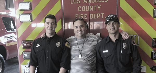 A close up photo of fire department workers in front of a fire truck.