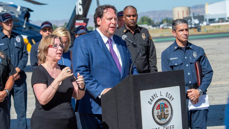 Press meeting next to a super scooper.